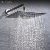 A Silver Shower head with water flowing against a gray background