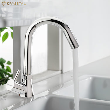 A silver kitchen sink tap with a high arch and a lever handle, dispensing water into a sink.