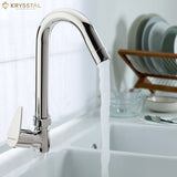 A silver kitchen sink tap with a swivel spout and a lever handle, against a kitchen backdrop with dishes.