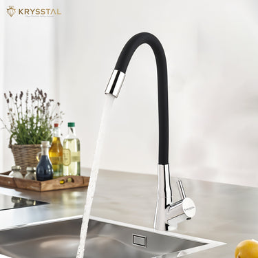 A black & silver mounted kitchen sink tap with a silicone spout, featuring a black flexible hose and a silver-colored faucet head with flowing water into the sink on a white backdrop.