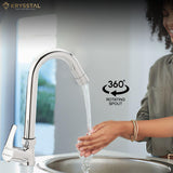 A cheerful woman washing her hands under the clear stream of a chrome kitchen faucet, advertised as having a fully 360 degree rotating spout for greater sink