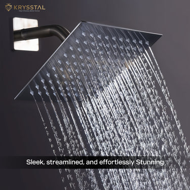 A silver overhead rain shower fitted against the black wall with water flowing from its nozzles.
