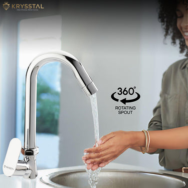 Close-up of a shiny chrome sink mixer tap with a side handle, with a woman washing her hands underneath. An overlay graphic points out the 360 degree rotating spout capability.
