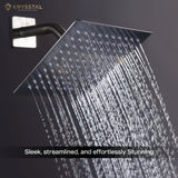 An overhead rain shower fitted against the black wall with water flowing from its nozzles.