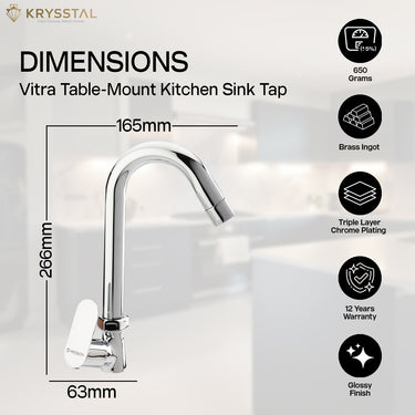 A chrome kitchen faucet is pictured in use, promoting the dimensions & advantage with warranty for multitasking in the sink on the blurred background.