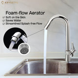 A chrome faucet with a paddle handle, set against a blurry kitchen backdrop, marketed with the key mechanical feature & foam flow aerator.