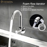 A silver kitchen sink tap with water flowing through it, featuring a foam-flow aerator. The brand name 'Krysstal' is visible in the top left corner.