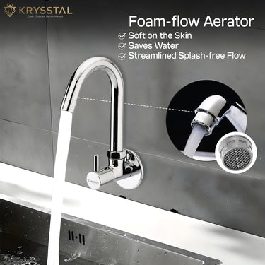 A silver kitchen sink tap with water flowing through it, featuring a foam-flow aerator. The brand name 'Krysstal' is visible in the top left corner.