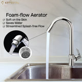 A stream of water flowing from a contemporary chrome kitchen faucet with foam flow aerator features is shown in the zoomed image.
