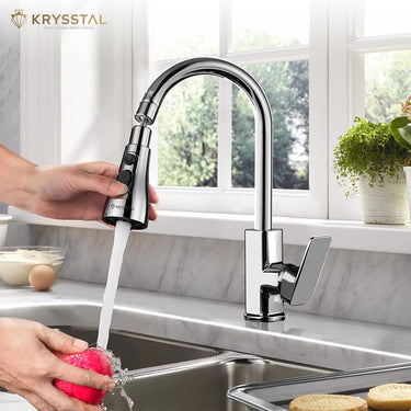 Silver-colored faucet aerator with hand-held pulling features showing while washing the apple, designed for kitchens.
