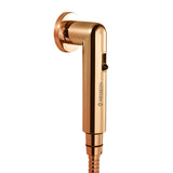 Rose gold colored health faucet with a shower tube and wall hook.