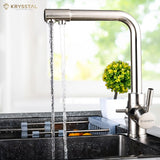 Silver-colored kitchen faucet set with an extra filtered water tap, shows while water flowing in 2 different way on transparent backdrop.
