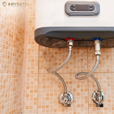 Water heater mounted on a colorful tiled wall with its connectors with visible branding.