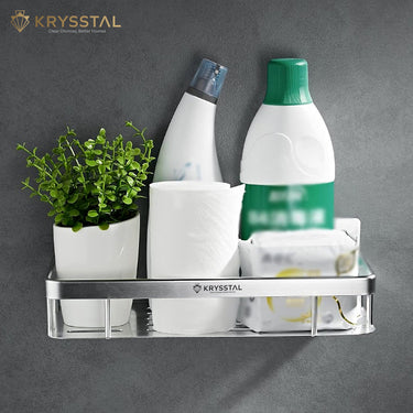 Metal silver wall shelf tray with flower pot, tissue, soap bar, and two bottles on a grey backdrop.