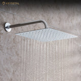 A silver overhead rain shower with straight water flowing from it fitted on a tile wall