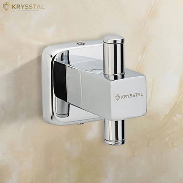 A silver square-shaped robe hook with a vertical rod extends from the square fitted on a beige background