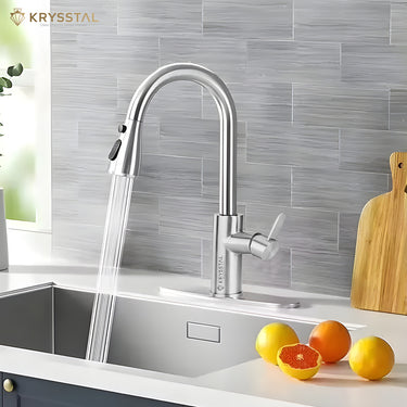 The silver finish Kitchen Sink mixer tap with dual water flowing & pull out features & 4 oranges put on the white  slab on a textured background.