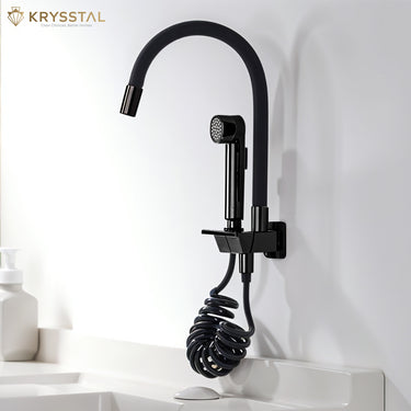 Sleek black kitchen faucet with hand spray and glossy piano finish fitted on a white wall.