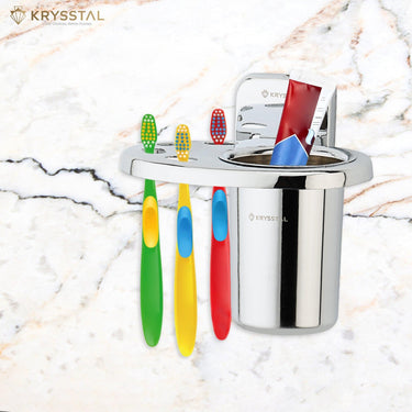 A stainless steel toothbrush holder with a set of colorful toothbrushes hanging from it, placed on a marble countertop.