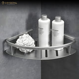A triangular silver SS corner shelf tray is attached to a grey wall with a white flower, and 2 white bottles are placed on it.