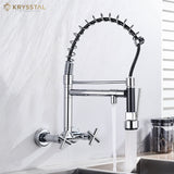 Chrome kitchen faucet with pull-down sprayer with dual controller fitted on a white wall, featuring the Krysstal brand.