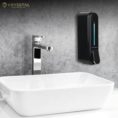 A black soap dispenser is mounted on a gray wall above a white sink with SS tap.