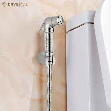 Chrome shower head with flexible hose against a marble wall, featuring the Krysstal brand.