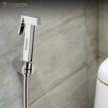 Chrome bathroom faucet with hose on a tiled wall, featuring the Krysstal brand.