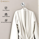 A stainless steel wall hook in silver with a round base and vertical crossbar with a bathrobe displayed on a grey backdrop.