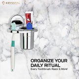 Silver toothbrush holder fixed on white & black texture tile surface holding a blue and white toothbrush and paste.