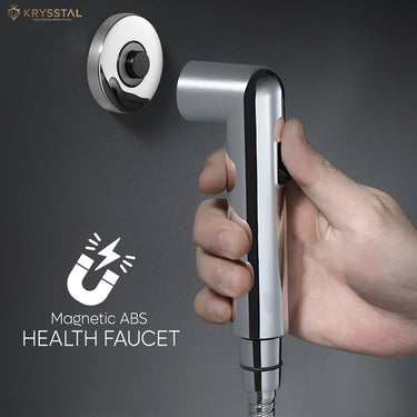 Black handheld health faucet with magnetic ABS effect and wall hook mounted on gray wall.