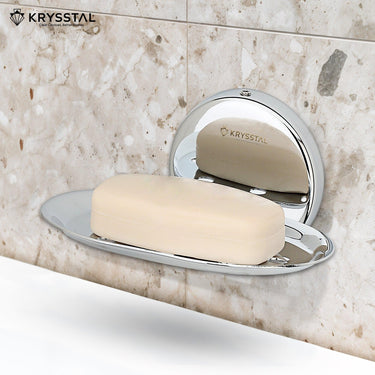 Silver soap dish stand reflecting on holder, carrying soap, mounted on a white texture wall.
