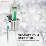 Modern steel toothbrush holder holding toothbrushes & paste placed on marble surface with tagline on right bottom side.