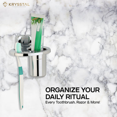 Modern steel toothbrush holder holding toothbrushes & paste placed on marble surface with tagline on right bottom side.