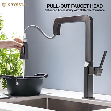 Black pull-out hand-held faucet head being used over a pot with a blurred background