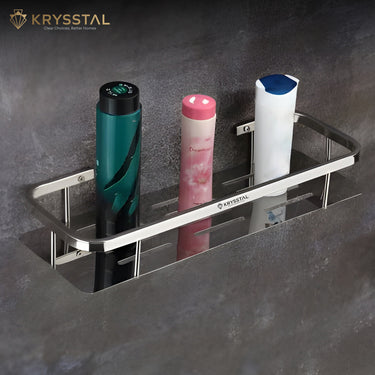 Silver SS wall shelf tray of medium size holding a perfume, body Powder, shampoo on a grey background