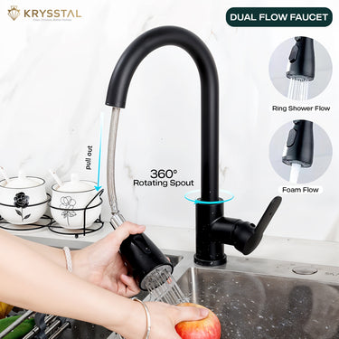 Black kitchen tap with 360 round rotating spout and hand-held with pull out by hand showing white washing the apple with "ring shower flow & foam flow" features fitted on a slab
