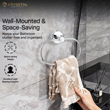 The hand-held towel is hanging on a silver stainless steel towel ring with a round wall-mounted base with some written lines and 2 features showing on the left side on a tile background.