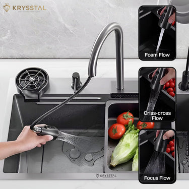 Stainless steel sink combining a handheld faucet with water spraying and a vegetable tray over a white tiled base.