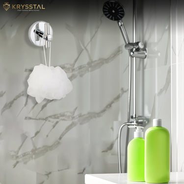 A round-base silver wall hook with upright bar, mounted on grey wall, supporting white scrub beside two green soap dispensers and SS showers.