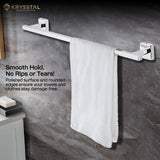 A white towel is put on a silver stainless steel towel rod with mounting brackets & a written tag line on the left side on a black wall background.