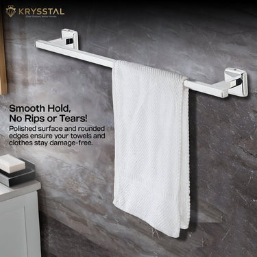 A white towel is put on a silver stainless steel towel rod with mounting brackets & a written tag line on the left side on a black wall background.