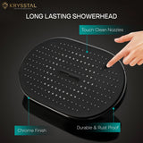 Black overhead rain shower with touch clean nozzles and a hand pointing to it, on a dark background.