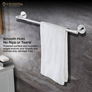 A white towel draped over a polished stainless steel rod with round ends on the black textured wall with the written bold tagline on the left side.