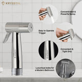 Chrome faucet with handheld shower head on a tiled bathroom wall background, featuring Krysstal branding.