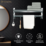 A silver towel rack fixed on a black wall with a white texture, with a right-side half-round mirror & at the bottom showing 3 features.