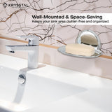 Wall-mounted & space saving silver soap dish holding soap, reflecting on the holder,on a white textured wall, with white washbasin with silver tap at the bottom