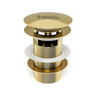 Gold sink drain assembly with Krysstal logo on a white background