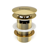 Gold sink drain assembly with Krysstal logo on a white background