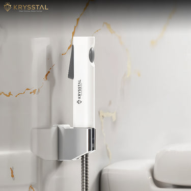 Wall-mounted shower head with Krysstal branding against a white marble wall.